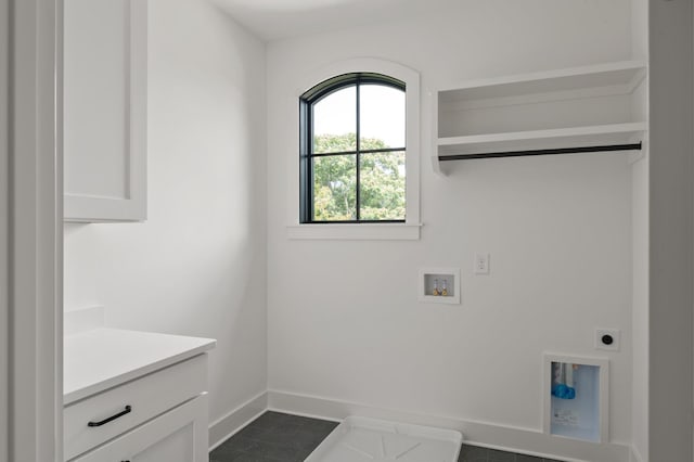 laundry area with cabinet space, hookup for a washing machine, electric dryer hookup, and baseboards