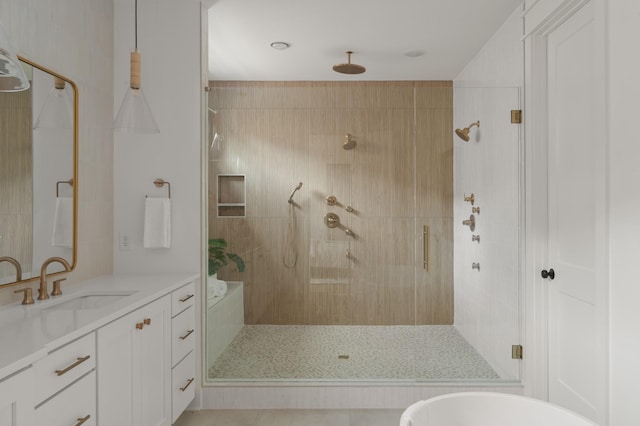 bathroom featuring a shower stall and vanity