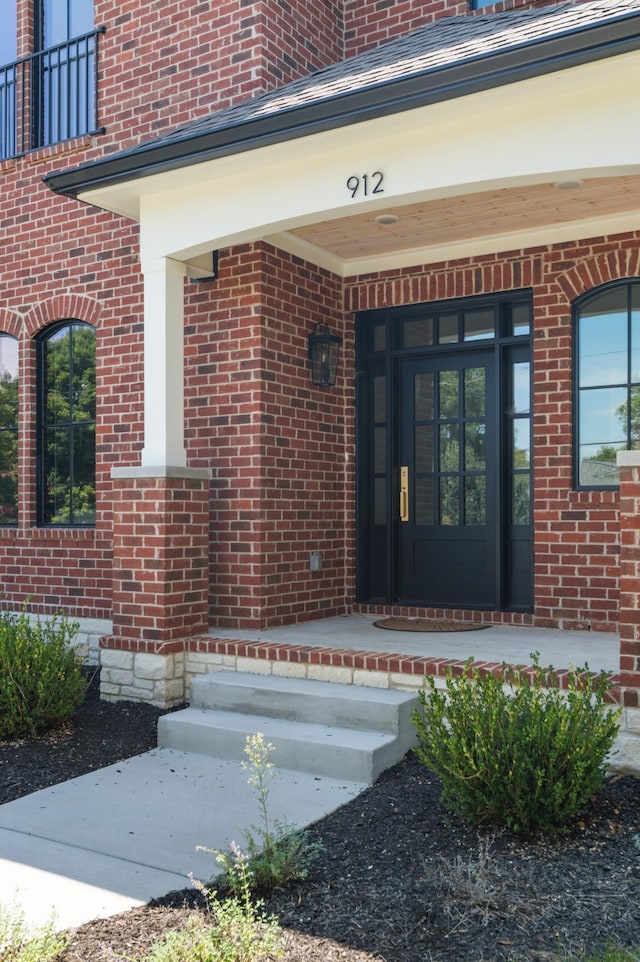 property entrance featuring brick siding