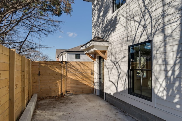 view of side of property with a patio and a fenced backyard