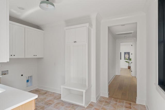 laundry room with hookup for a washing machine, visible vents, cabinet space, electric dryer hookup, and baseboards