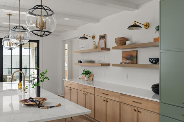 kitchen with hanging light fixtures, beam ceiling, light brown cabinetry, open shelves, and a sink