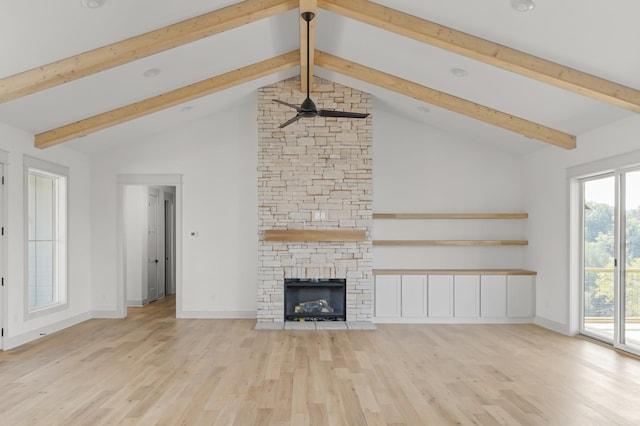 unfurnished living room with a fireplace, wood finished floors, beam ceiling, and baseboards