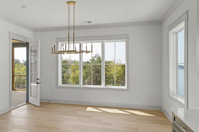 unfurnished dining area with a wealth of natural light, visible vents, and light wood-style flooring