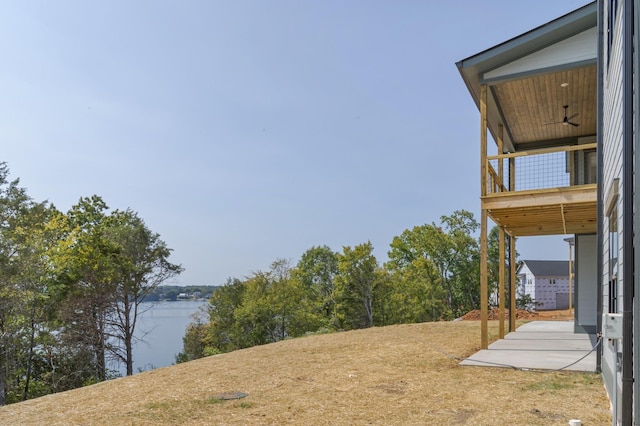 view of yard featuring a water view and a balcony