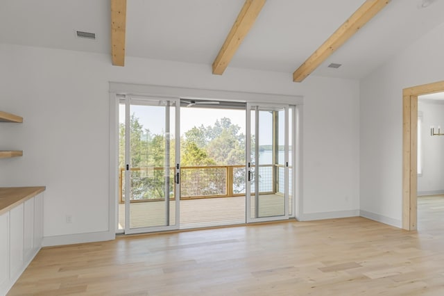 interior space featuring vaulted ceiling with beams, light wood finished floors, baseboards, and visible vents