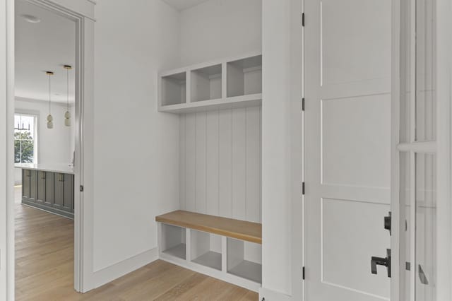 mudroom with baseboards and light wood-style floors