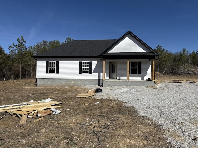 view of front of property featuring a porch and roof with shingles