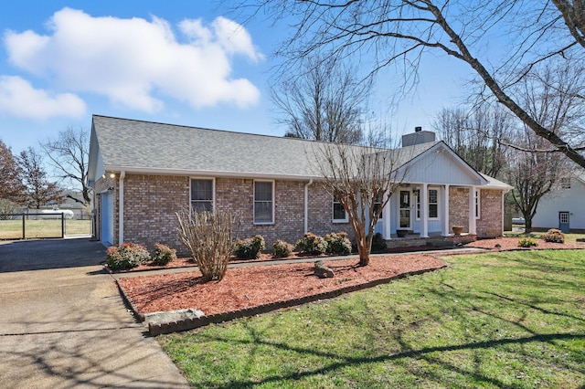 ranch-style house with a chimney, aphalt driveway, fence, a front lawn, and brick siding