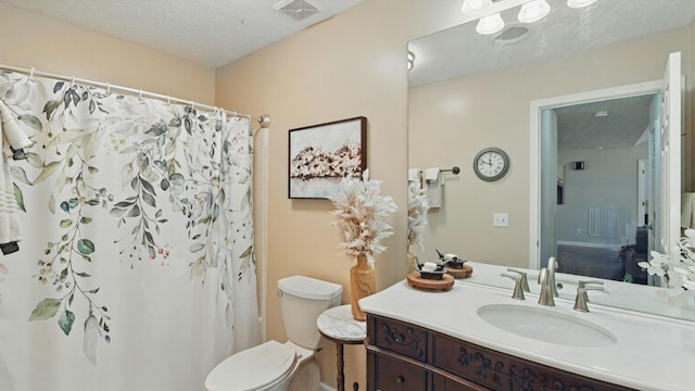 bathroom featuring visible vents, a shower with shower curtain, toilet, a textured ceiling, and vanity