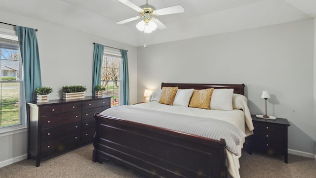 bedroom featuring light carpet, ceiling fan, and baseboards