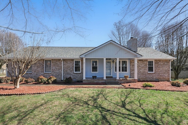 single story home with crawl space, a chimney, a front lawn, and brick siding