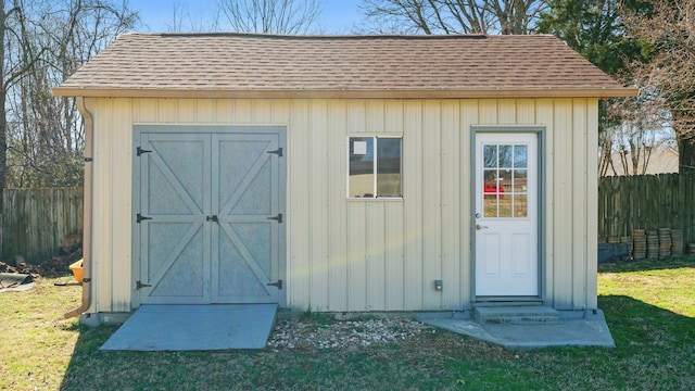 view of shed featuring fence