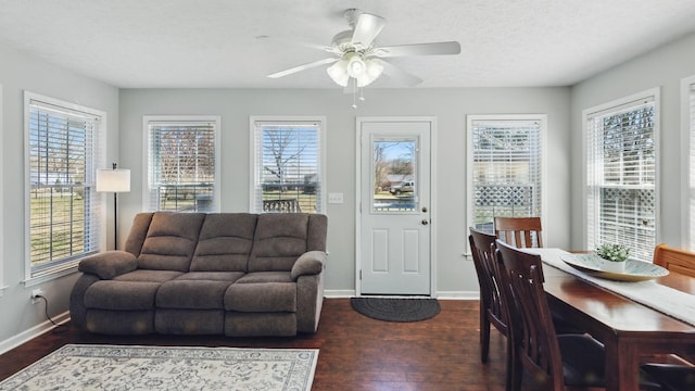 sunroom / solarium featuring a healthy amount of sunlight and ceiling fan