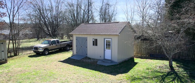 view of shed featuring fence