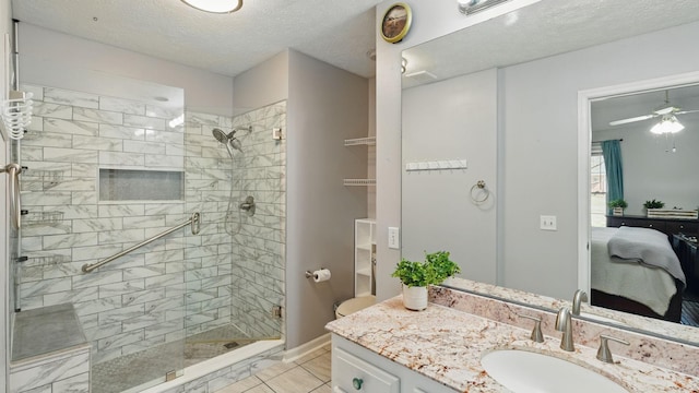 bathroom with baseboards, connected bathroom, a textured ceiling, vanity, and a shower stall