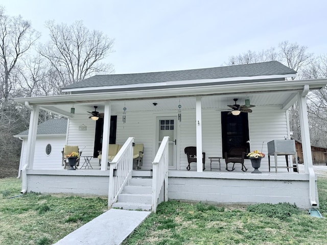 bungalow-style house with covered porch, ceiling fan, and roof with shingles