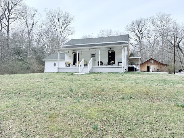 view of front of property with a porch, a front yard, and a shingled roof