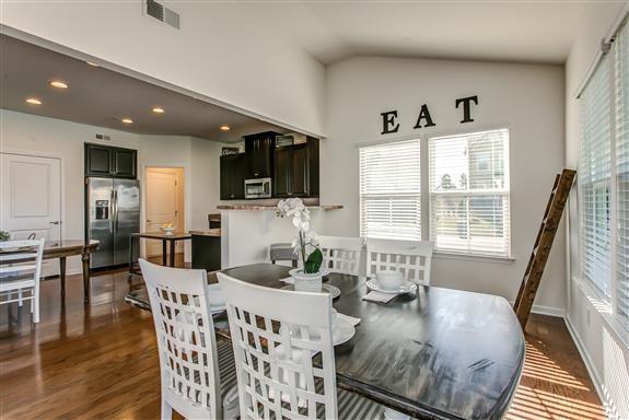 dining room with lofted ceiling, recessed lighting, visible vents, baseboards, and dark wood finished floors