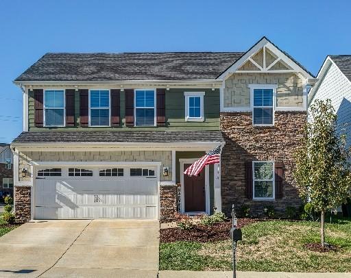 craftsman-style home with driveway and a garage