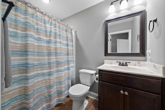 bathroom with baseboards, toilet, wood finished floors, curtained shower, and vanity