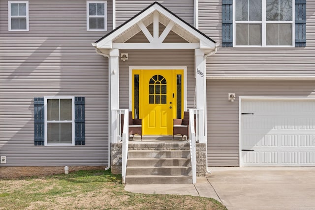 view of exterior entry with a garage