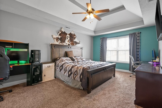 bedroom with carpet floors, a raised ceiling, visible vents, ceiling fan, and baseboards