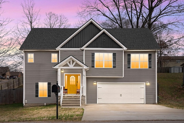 view of front of house featuring an attached garage, fence, driveway, roof with shingles, and board and batten siding