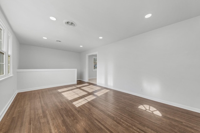 unfurnished room with wood finished floors, visible vents, and recessed lighting