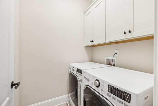 laundry room featuring independent washer and dryer, cabinet space, and baseboards