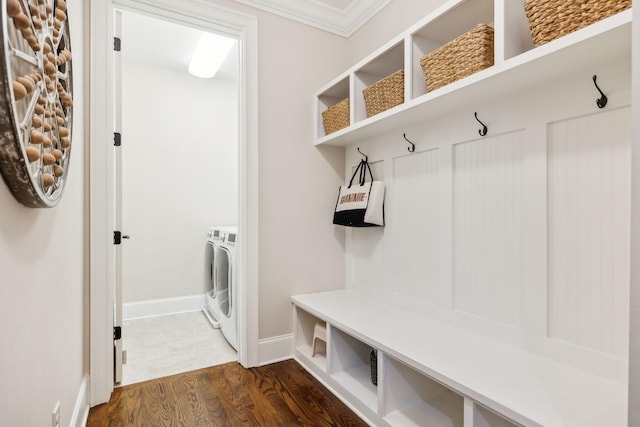 mudroom featuring crown molding, baseboards, washer and clothes dryer, and dark wood-type flooring