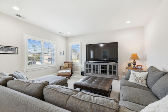 carpeted living room with recessed lighting, visible vents, and baseboards