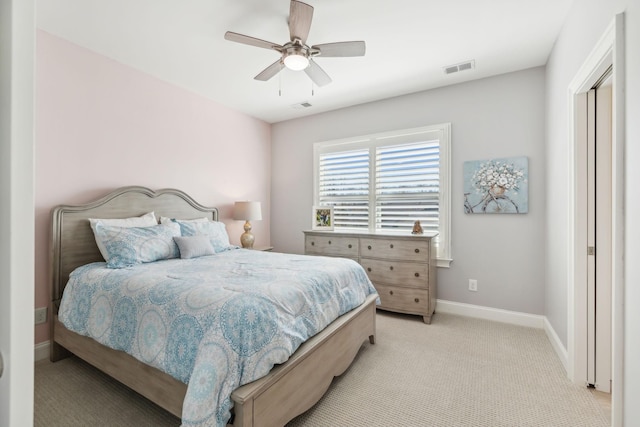 bedroom with a ceiling fan, light colored carpet, visible vents, and baseboards