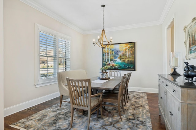 dining room with a notable chandelier, dark wood-type flooring, ornamental molding, and baseboards