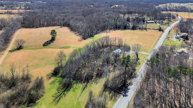 drone / aerial view featuring a rural view and a view of trees