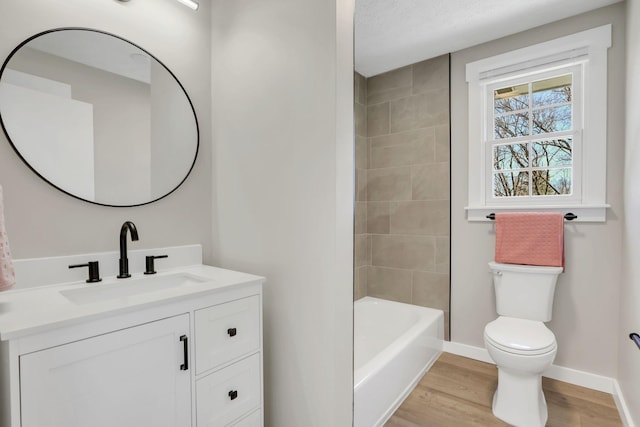 full bath featuring baseboards, vanity, toilet, and wood finished floors