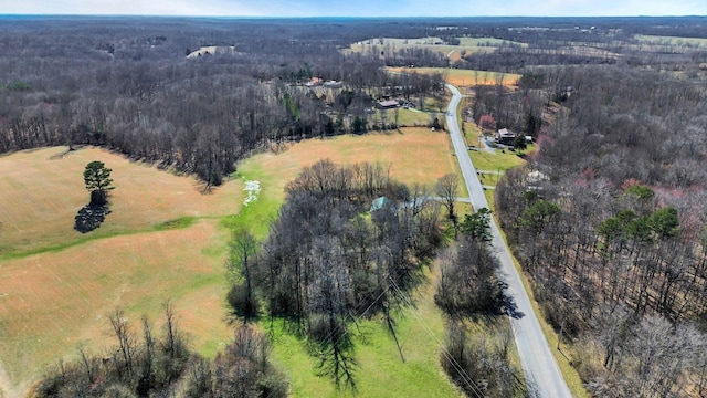 birds eye view of property with a rural view and a wooded view