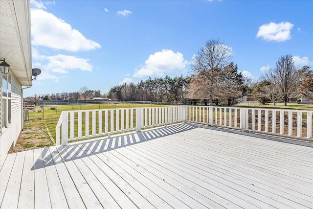 wooden terrace with fence and a lawn