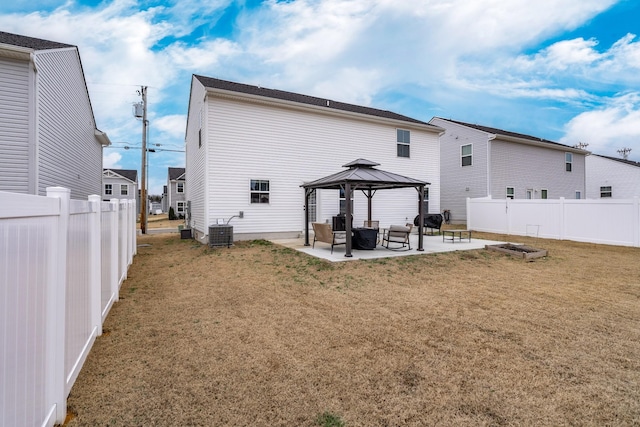 back of house with a patio, a lawn, a gazebo, central AC unit, and fence