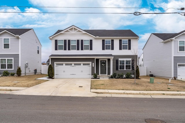 craftsman-style home featuring a garage and concrete driveway