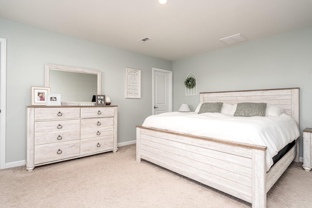 bedroom with visible vents, light carpet, and baseboards