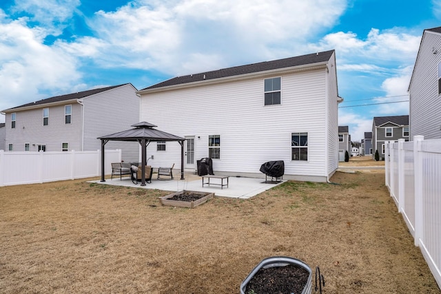 back of house with a patio, a lawn, a gazebo, and a fenced backyard