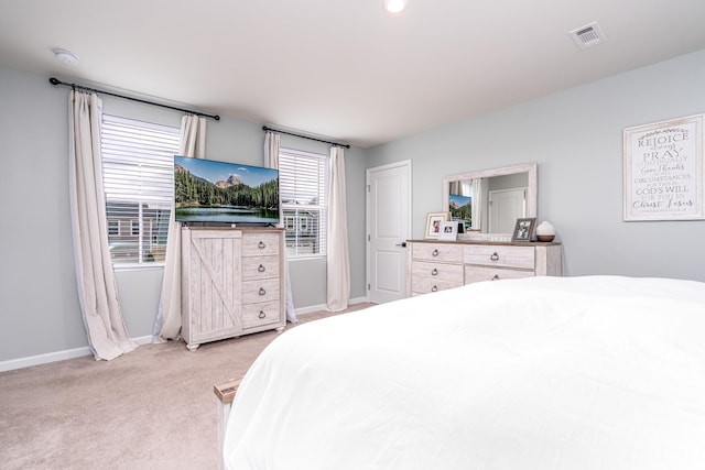 bedroom with light carpet, baseboards, and visible vents