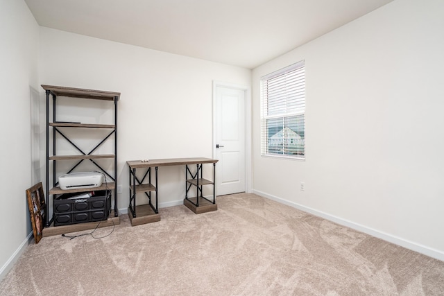 carpeted office space featuring baseboards