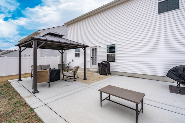 view of patio featuring fence, an outdoor living space, area for grilling, and a gazebo