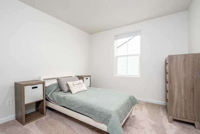 bedroom with carpet floors and baseboards