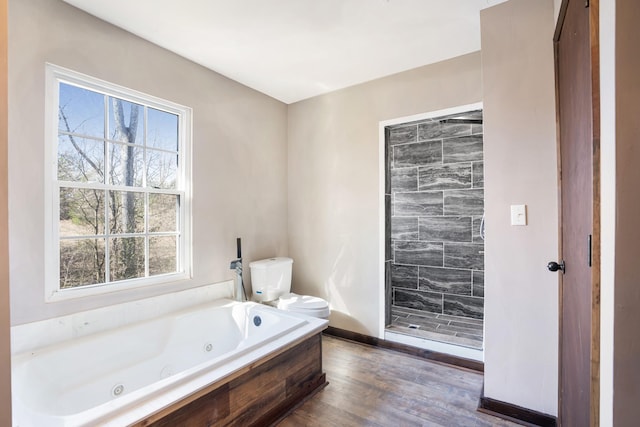 bathroom with toilet, tiled shower, a whirlpool tub, and wood finished floors
