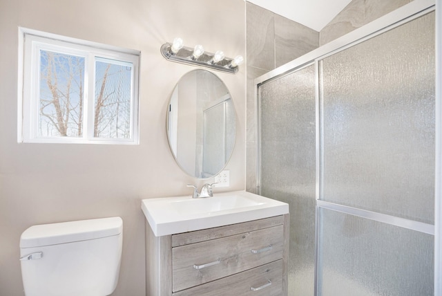 full bathroom featuring a shower with door, toilet, and vanity