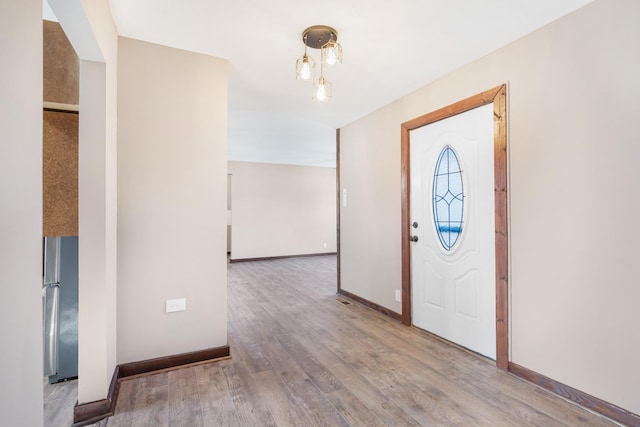entryway featuring baseboards and wood finished floors