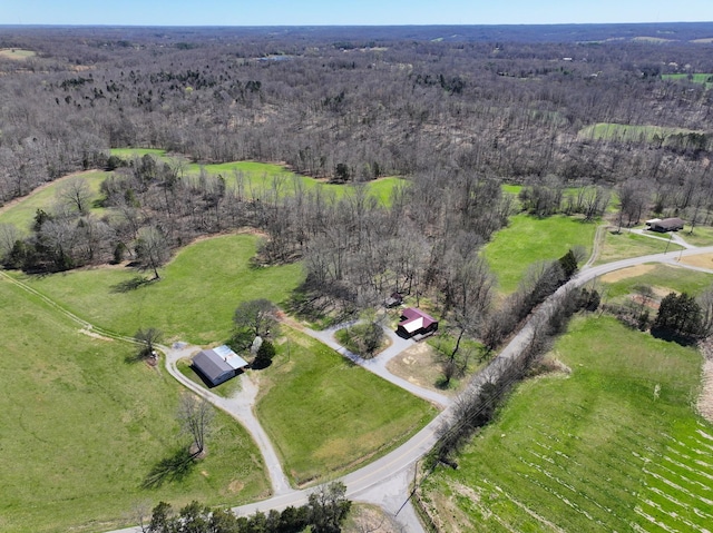 birds eye view of property featuring a view of trees